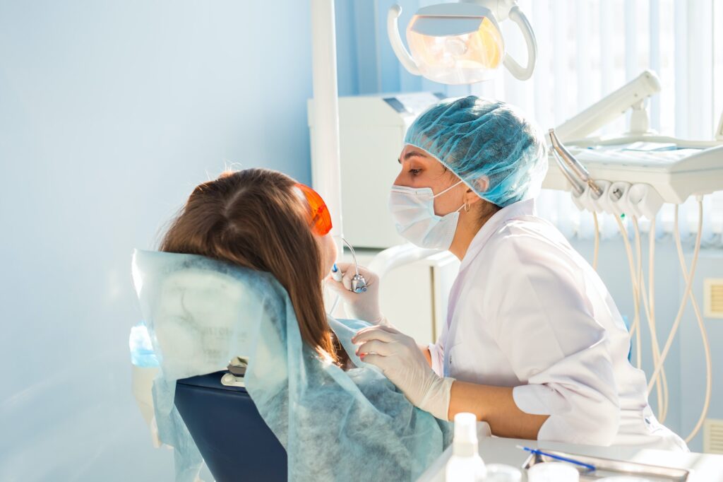 young woman getting dental treatment dental clinic